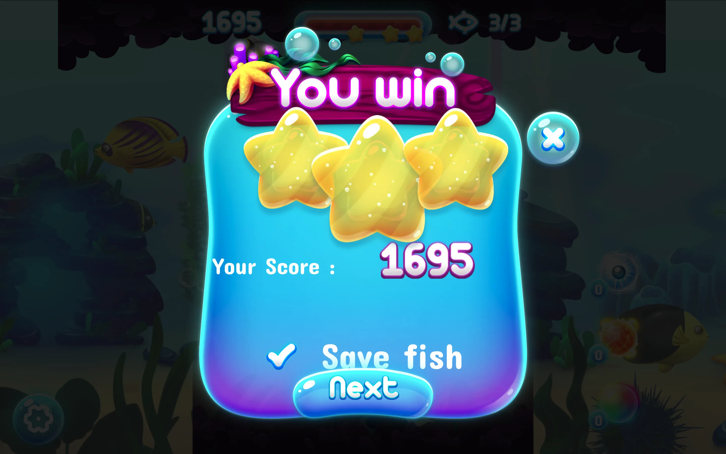 Aqua Pop Bubble Shooter victory screen displaying three gold stars, 1695 points, and Save fish confirmation
